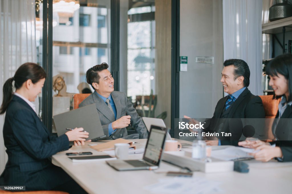 Asian Businessmen cheerful discussion in meeting room Gender Equality Stock Photo