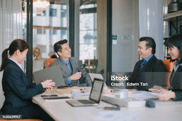Asian Businessmen Cheerful Discussion In Meeting Room Stock Photo - Download Image Now