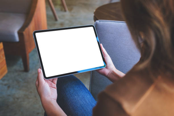 istock Mockup image of a woman holding digital tablet with blank white desktop screen 1420640039
