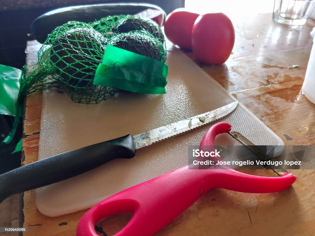 Avocado cutting tomatoes and cucumber peeling Color Image Stock Photo