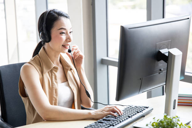 istock Call center woman advising customers calling. 1420644128
