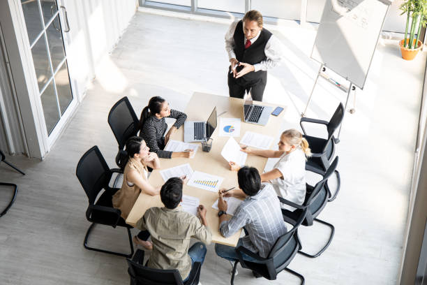 istock Top view of team meeting to analyze assignments. 1420644922