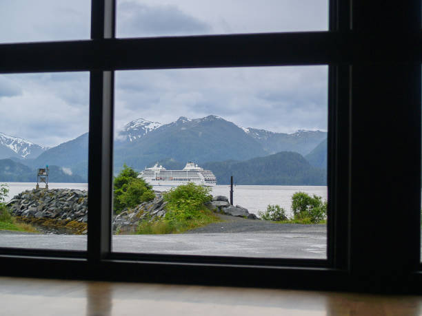 istock View through window of dramatic Alaskan scenery and passing cruise-ship 1420646214
