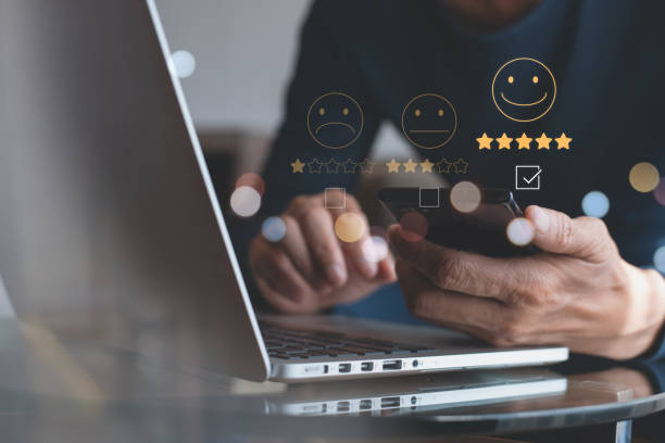 istock Man pressing face emoticon on virtual touch screen on mobile smart phone. Customer review, service evaluation concept 1420650893
