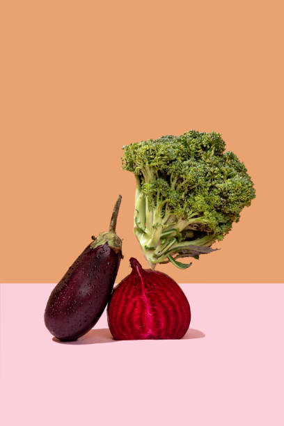 istock Broccoli, beet and eggplant on a light background. Modern still life. Levitation. Healthy organic food concept 1420651967