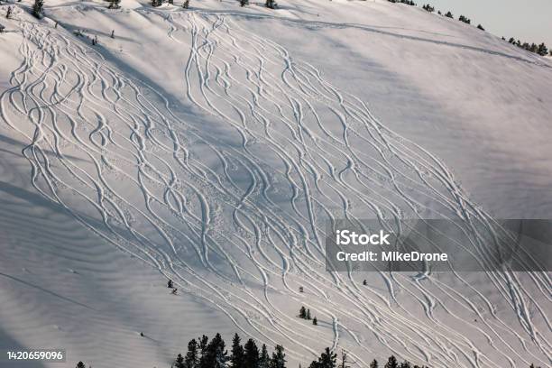 Snowy Offpiste Ski Slope With Traces Of Skis And Snowboards On A Winter Day Stock Photo - Download Image Now