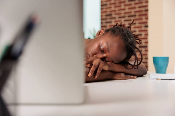 istock Tired overworked employee sleeping on desk at daytime 1420661921