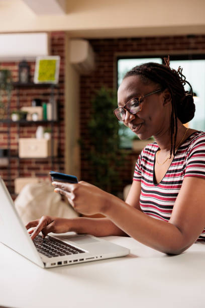 istock Buyer holding debit card, shopping using laptop, making payment 1420661961