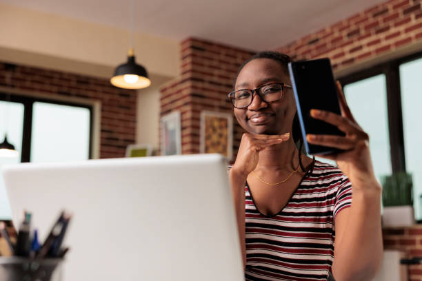 istock Young woman taking face selfie on smartphone 1420661976