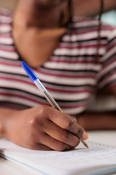 istock African american woman hand writing in notepad close up 1420662053
