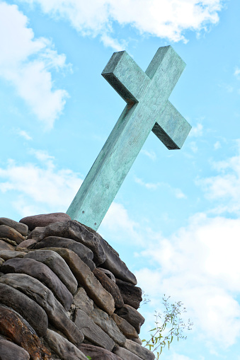 Cross on top of a mound of rock.
