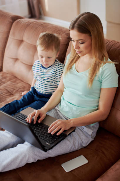 istock Lonely mother and son using laptop together 1420667883