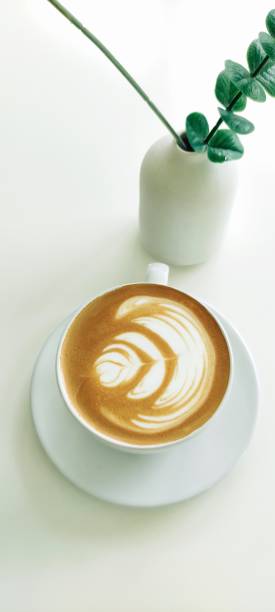 Close up shot of hot coffee latte forth art.