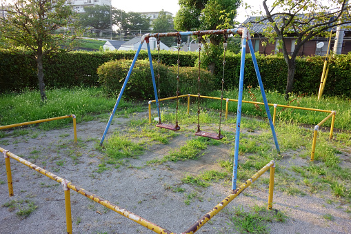 Children's playground in a park with well-designed swing equipment