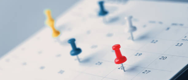 istock Embroidered red pins on a calendar event Planner calendar,clock to set timetable organize schedule,planning for business meeting or travel planning concept. 1420678575