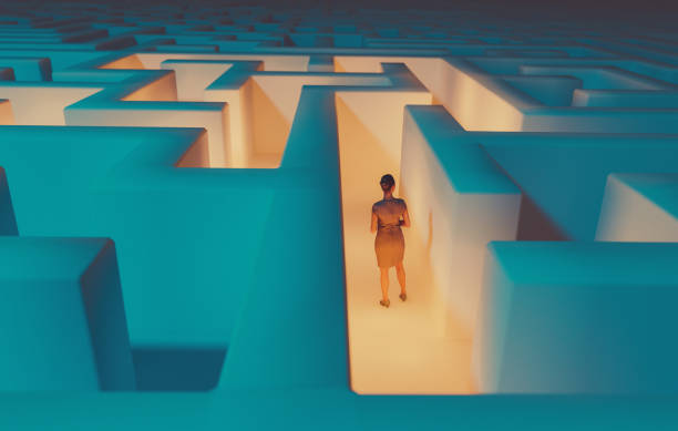 Businesswoman looks for the right way out of a maze stock photo