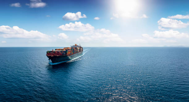istock Panoramic front view of a cargo ship carrying containers for import and export 1420679501