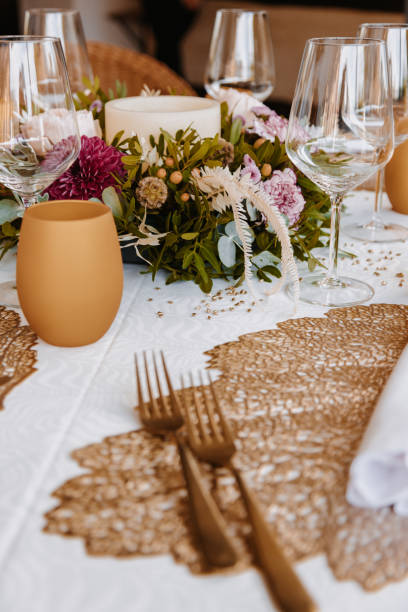 istock Boho wedding banquet table with a bouquet in the centre and crockery and selective focus 1420679532