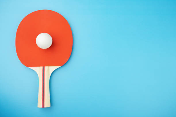 istock ping pong racket and ball on a blue background,copy space 1420680003