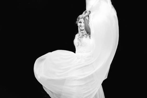istock Beautiful bride throwing up her airy dress and smiling cheerfull 1420680182