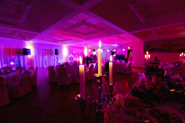 Candles lighting in a luxury restaurant on a wedding table set decorations