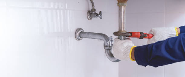 istock Plumber fixing white sink pipe with adjustable wrench. 1420680737