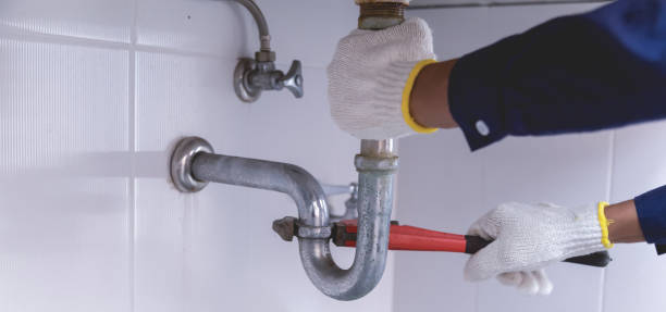 istock Plumber fixing white sink pipe with adjustable wrench. 1420680752