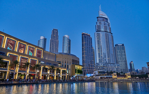 Dubai, United Arab Emirates - May 30, 2022: the luxury hotel Address Downtown and The Dubai Mall at sunset.