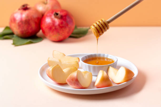 gros plan de l’assiette avec des pommes et du miel pour la fête juive rosh hashanah - photos de shana tova photos et images de collection