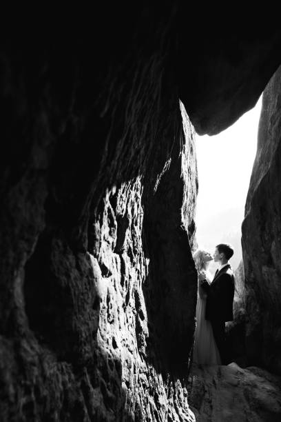 istock Passionate couple standing alone surrounded by rocks 1420686005