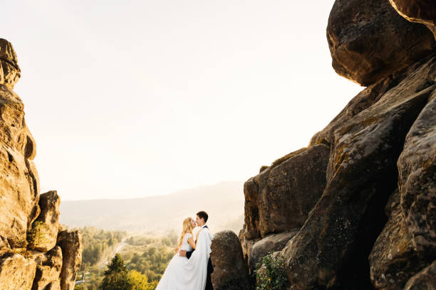 istock Lovely wedding couple softly hugging. Beautiful mountain landsca 1420686710
