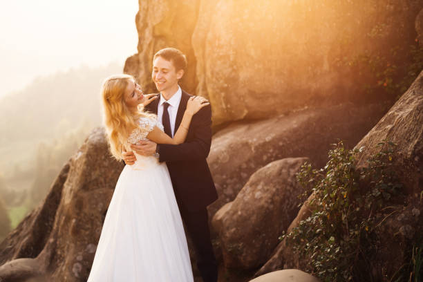 istock couple against rocks in mountains on sunset 1420686719