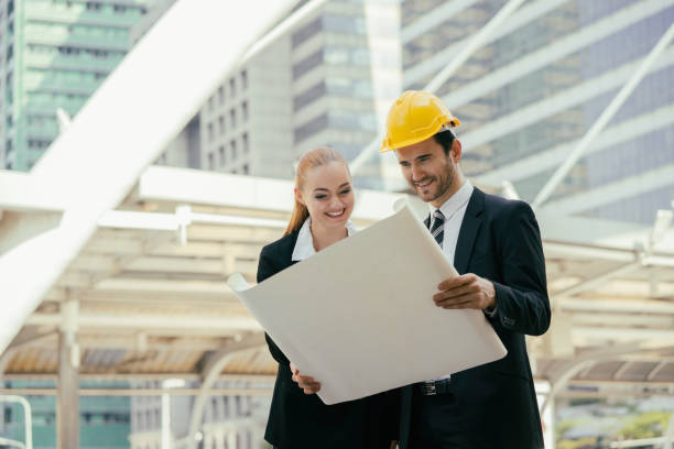 architect people working with tablets laptop and blueprints,engineer inspection in workplace for architectural plan,sketching a construction project ,Business concept stock photo