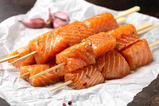istock Fresh raw salmon skewers with herbs and ready to cook 1420690861