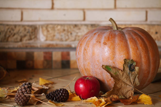 istock Round pumpkin and apple lie on shelf 1420691004