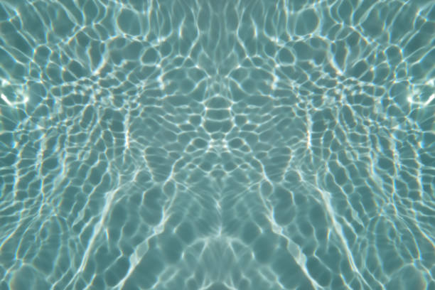 Empty rubber transparent ring floating on blue water surface in swimming pool. Bright summer background. Vacation concept. Color of the year 2022 inspired