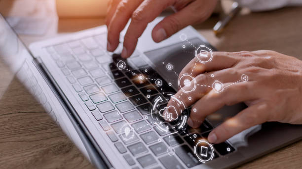 istock businessman working on his laptop in the office, select the icon cloud on the virtual display. Concept digital technology and cloud technology 1420699388