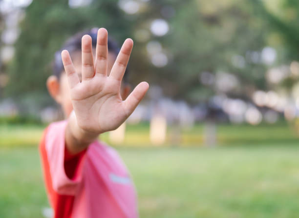 istock Little Girl Occlusion Face with Hand Say NO 1420700722