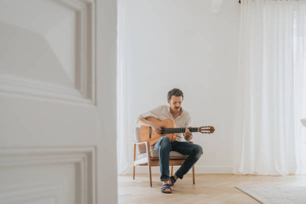 Man playing guitar in the living room