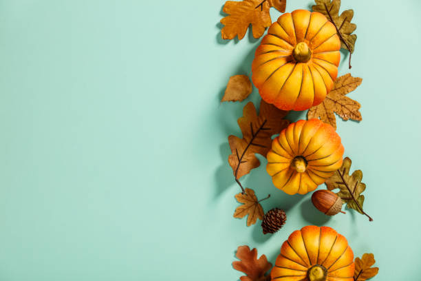 istock Autumn background creative layout with decorative small pumpkins and autumn leaves 1420713113
