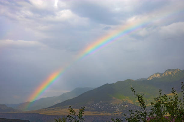 istock Rainbow over a village in the mountains 1420714823