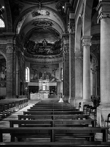 interior of a church with a nun praying