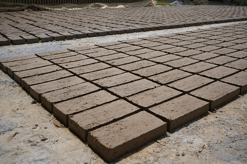 Several pallets with red perforated brick in depot.