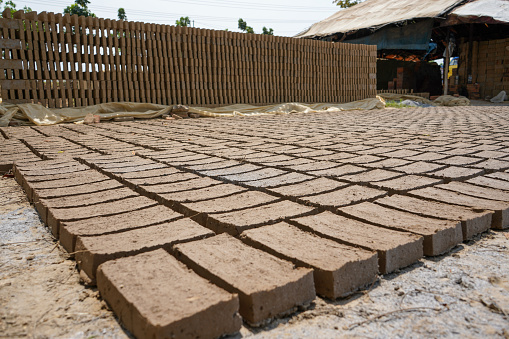 Red bricks from clay. After the clay is molded into bricks, after that it is laid out and dried in the yard in the sun before being burned to make it hard and dry. Pile of making batu bata merah.