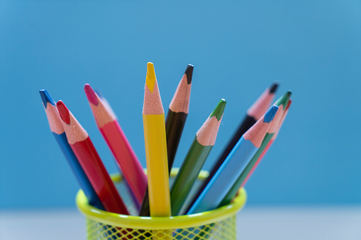many colorful pencils with blue background