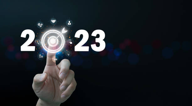 finger pressing blue start 2023 button on virtual interface on gray background with copy space for text. concept of new year. businessman pressing 2023 start up business. - celebration imagens e fotografias de stock