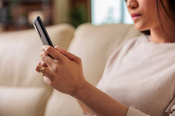 istock Casual happy asian woman using smartphone at home 1420723150