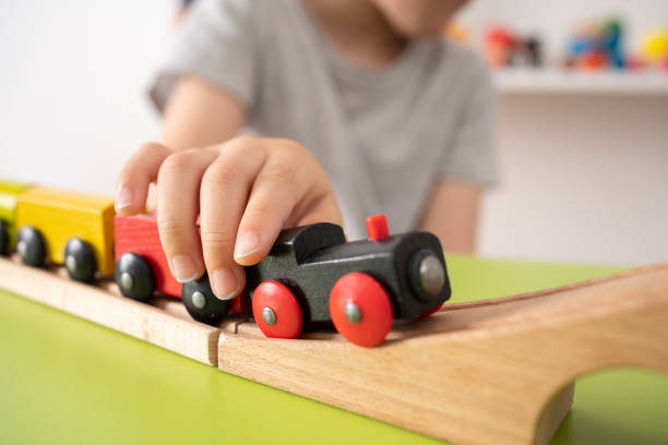 istock Kid playing with wooden toy train 1420724309