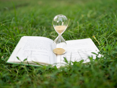 Hourglass and book