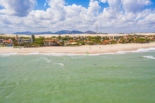 Aerial view of some people kitesurfing on a sunny day
